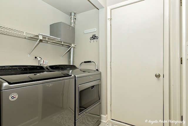 clothes washing area featuring washer and clothes dryer