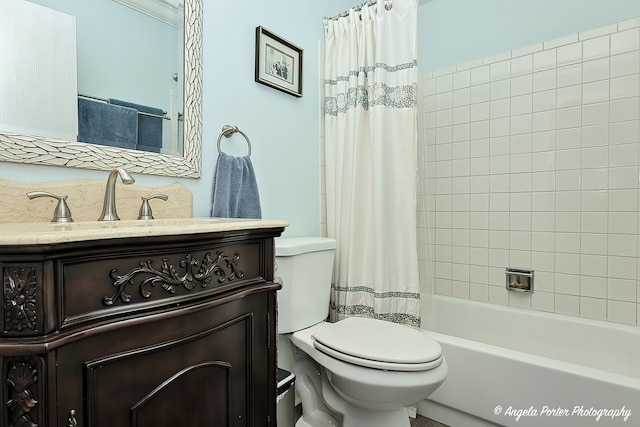 full bathroom featuring shower / bath combo with shower curtain, vanity, and toilet