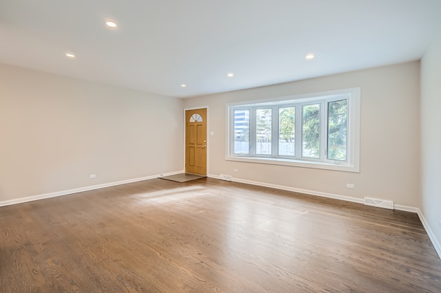 unfurnished living room with dark hardwood / wood-style floors