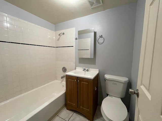 full bathroom with tile patterned flooring, vanity, toilet, and tiled shower / bath