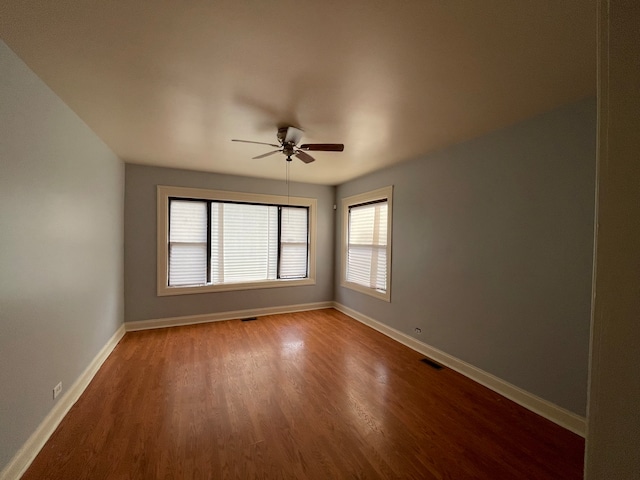 unfurnished room with hardwood / wood-style floors and ceiling fan