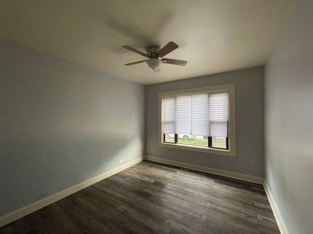 spare room with ceiling fan and dark hardwood / wood-style flooring