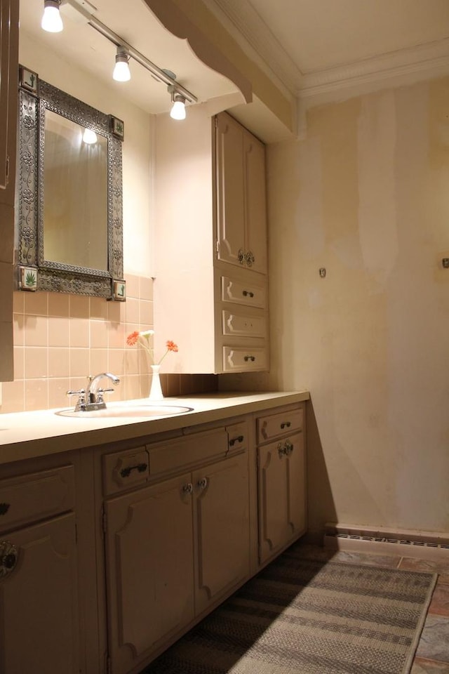 bathroom featuring vanity, crown molding, and tasteful backsplash