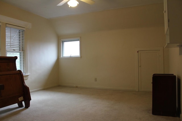 bedroom with ceiling fan, light carpet, and vaulted ceiling