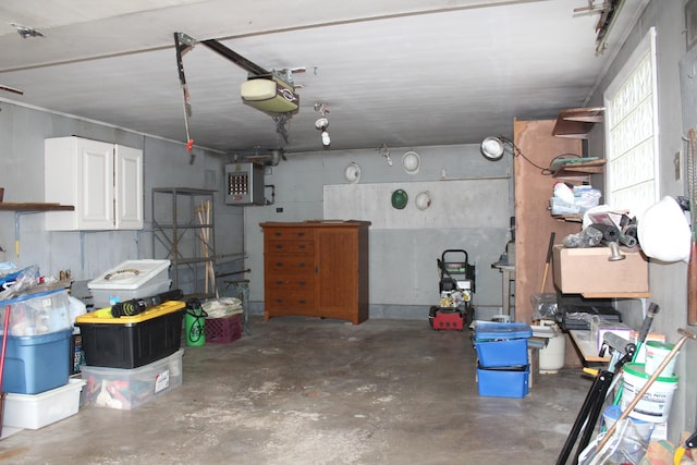 garage featuring electric panel and a garage door opener