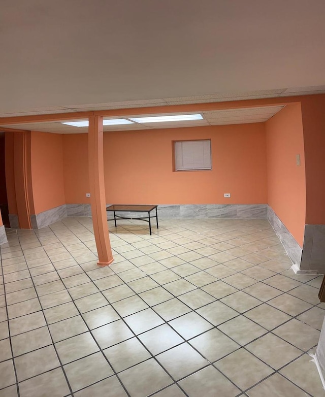 basement featuring light tile patterned flooring