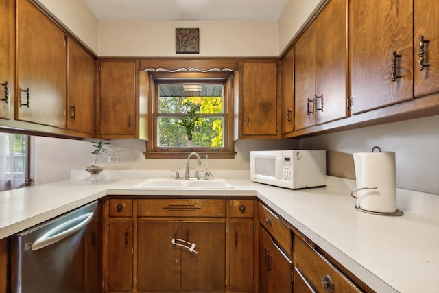 kitchen with a healthy amount of sunlight, stainless steel dishwasher, and sink