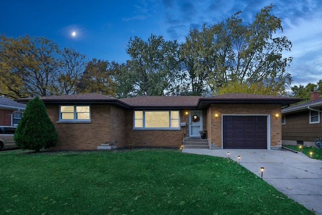 ranch-style home featuring a yard and a garage