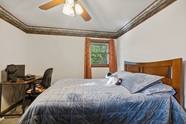 carpeted bedroom with ornamental molding and ceiling fan