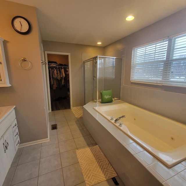 bathroom featuring shower with separate bathtub, tile patterned floors, and vanity