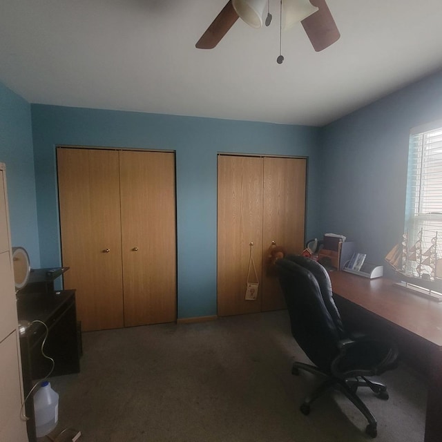 office area with ceiling fan and dark carpet