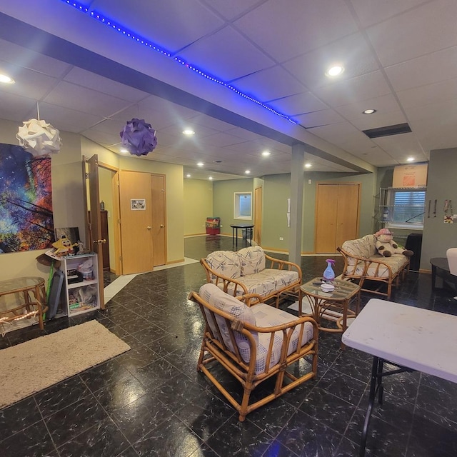 living room featuring a paneled ceiling