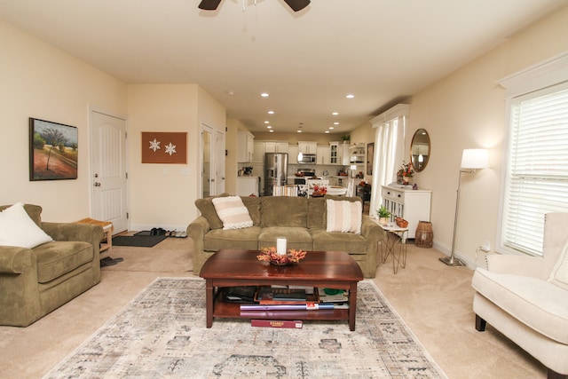 living room with light colored carpet and ceiling fan