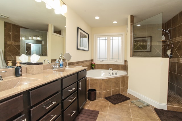 bathroom featuring vanity, plus walk in shower, and tile patterned flooring