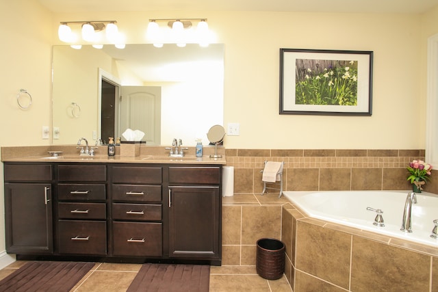 bathroom featuring vanity, tile patterned floors, and tiled bath