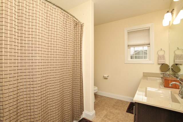 bathroom featuring vanity, curtained shower, toilet, and tile patterned flooring