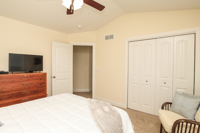 carpeted bedroom featuring vaulted ceiling, a closet, and ceiling fan