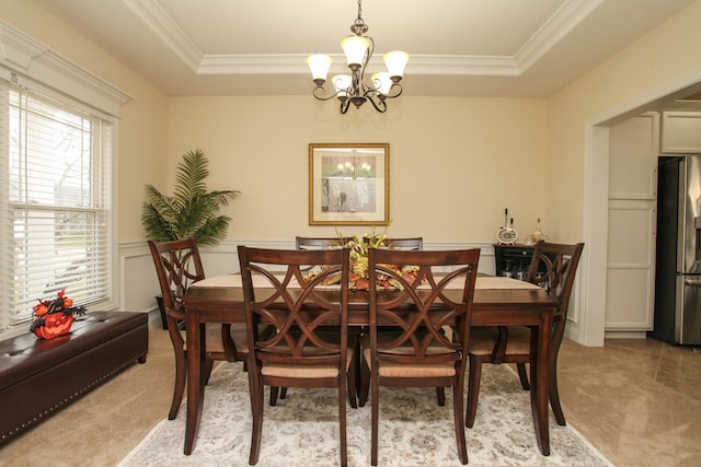 dining room with a tray ceiling, a wealth of natural light, and a chandelier