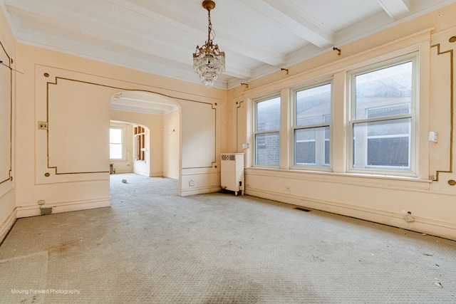 carpeted empty room featuring beam ceiling, crown molding, radiator heating unit, and an inviting chandelier