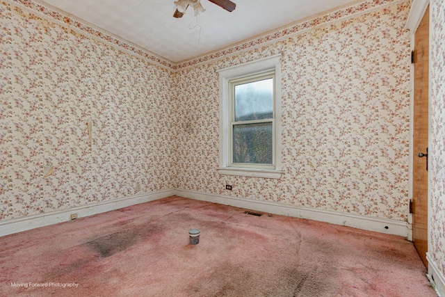 carpeted empty room featuring ceiling fan