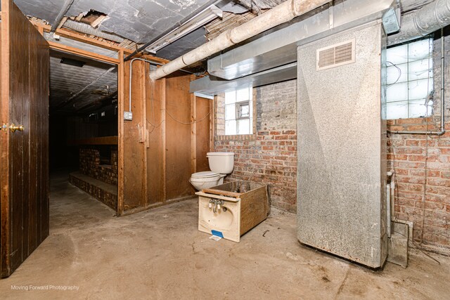 basement with brick wall