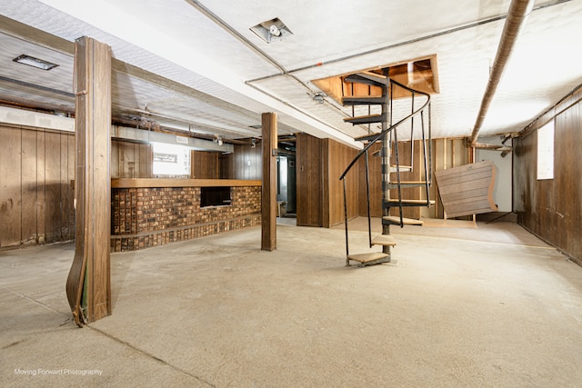 basement featuring wood walls