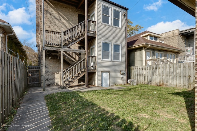 rear view of house featuring a yard