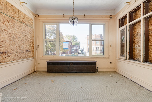 unfurnished sunroom featuring a notable chandelier, radiator heating unit, and plenty of natural light