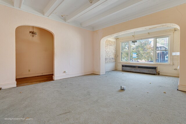 unfurnished living room with beam ceiling, carpet, and radiator heating unit