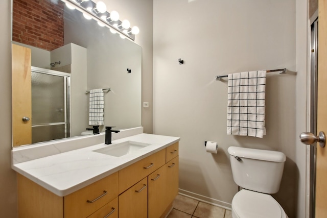 bathroom with toilet, walk in shower, vanity, and tile patterned flooring