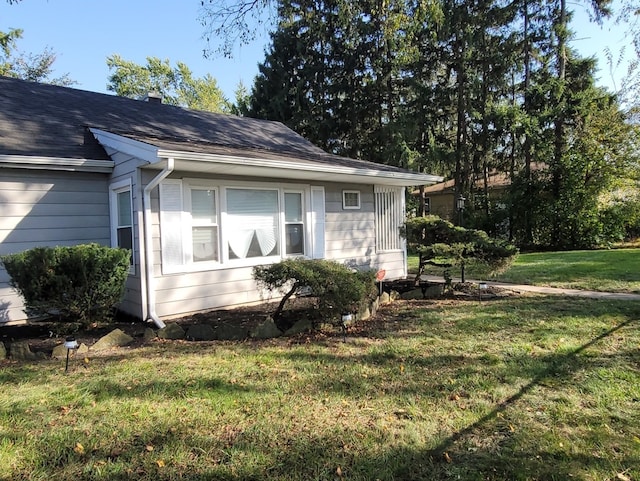 view of side of property with a lawn