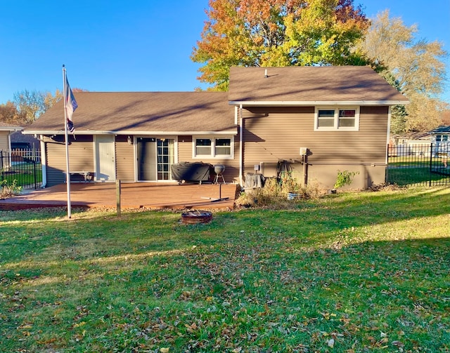 rear view of house with a yard and a deck