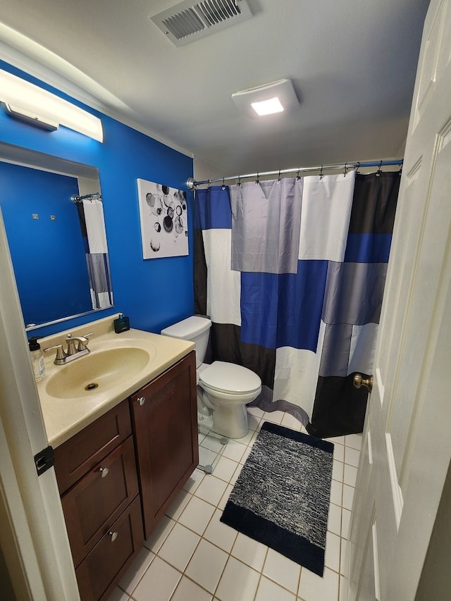 bathroom featuring toilet, vanity, tile patterned floors, and walk in shower