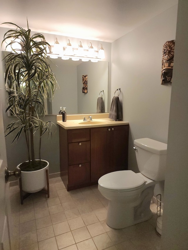 bathroom featuring tile patterned flooring, vanity, and toilet