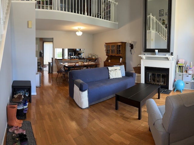 living room with hardwood / wood-style floors and a high ceiling