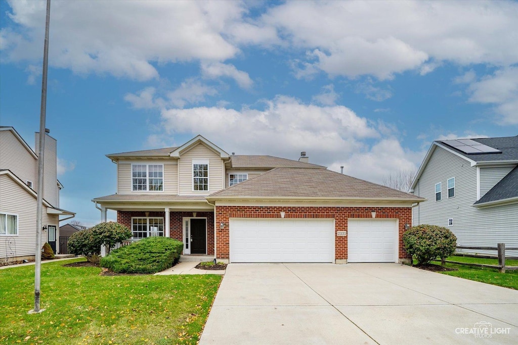 front of property with a garage and a front lawn