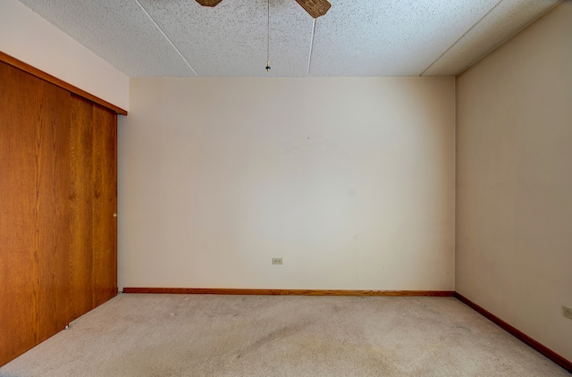 unfurnished room featuring ceiling fan and light colored carpet