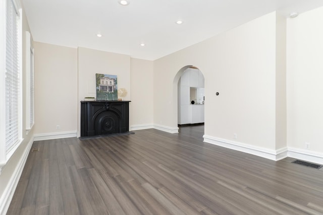 unfurnished living room with dark hardwood / wood-style floors