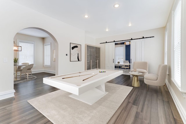 game room featuring billiards, a barn door, and dark hardwood / wood-style floors