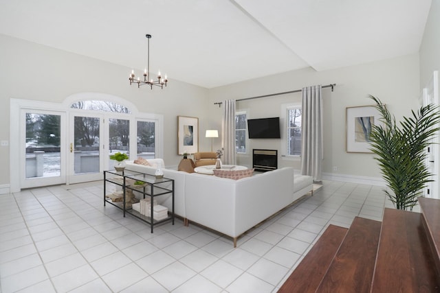 living room featuring an inviting chandelier and light tile patterned floors