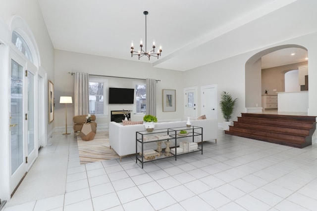 living room with light tile patterned flooring and a notable chandelier