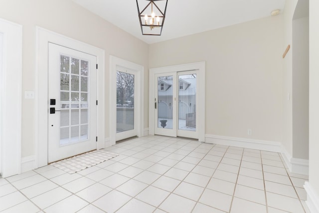 interior space with an inviting chandelier and light tile patterned floors