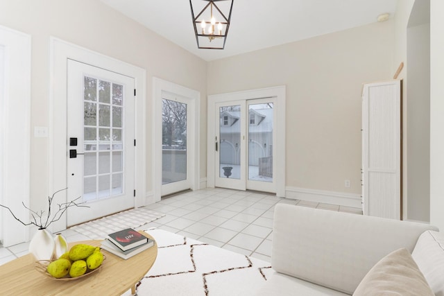 doorway with an inviting chandelier and light tile patterned floors