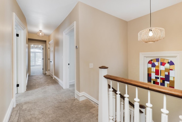 corridor featuring light colored carpet