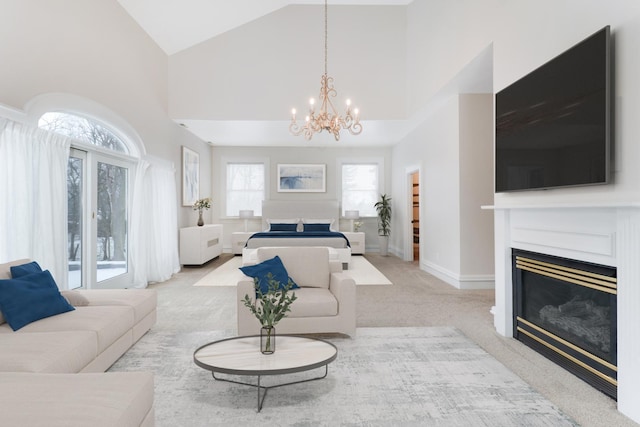 carpeted living room with a notable chandelier and high vaulted ceiling