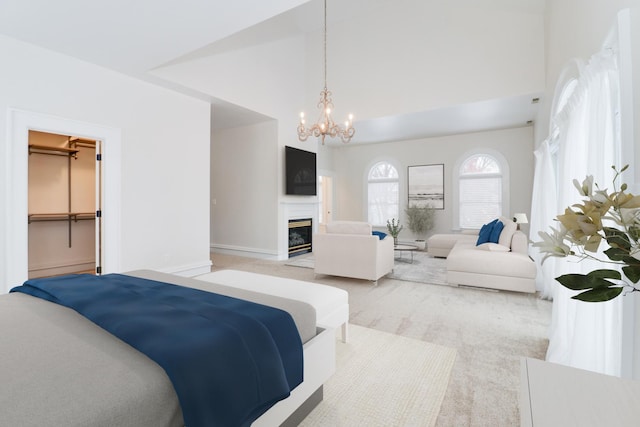 bedroom with a walk in closet, an inviting chandelier, and high vaulted ceiling