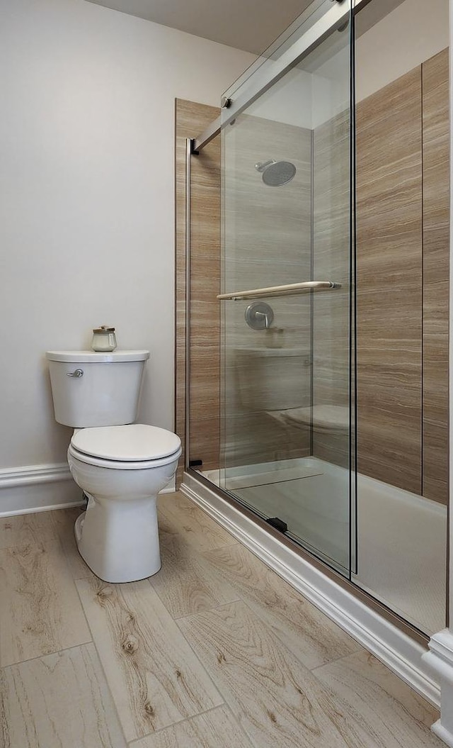 bathroom featuring toilet and walk in shower