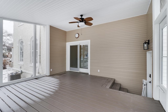 unfurnished sunroom featuring ceiling fan and a healthy amount of sunlight