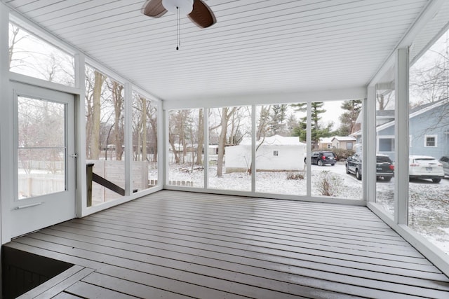 unfurnished sunroom with ceiling fan