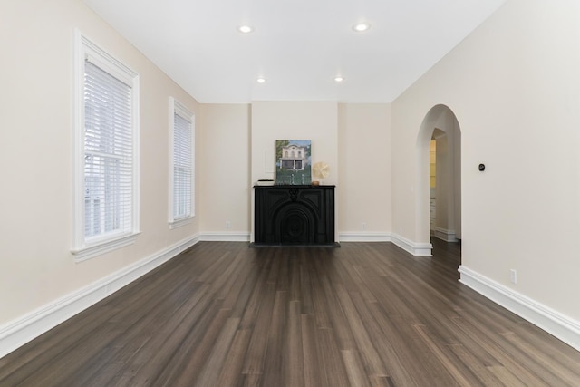 unfurnished living room featuring dark hardwood / wood-style floors